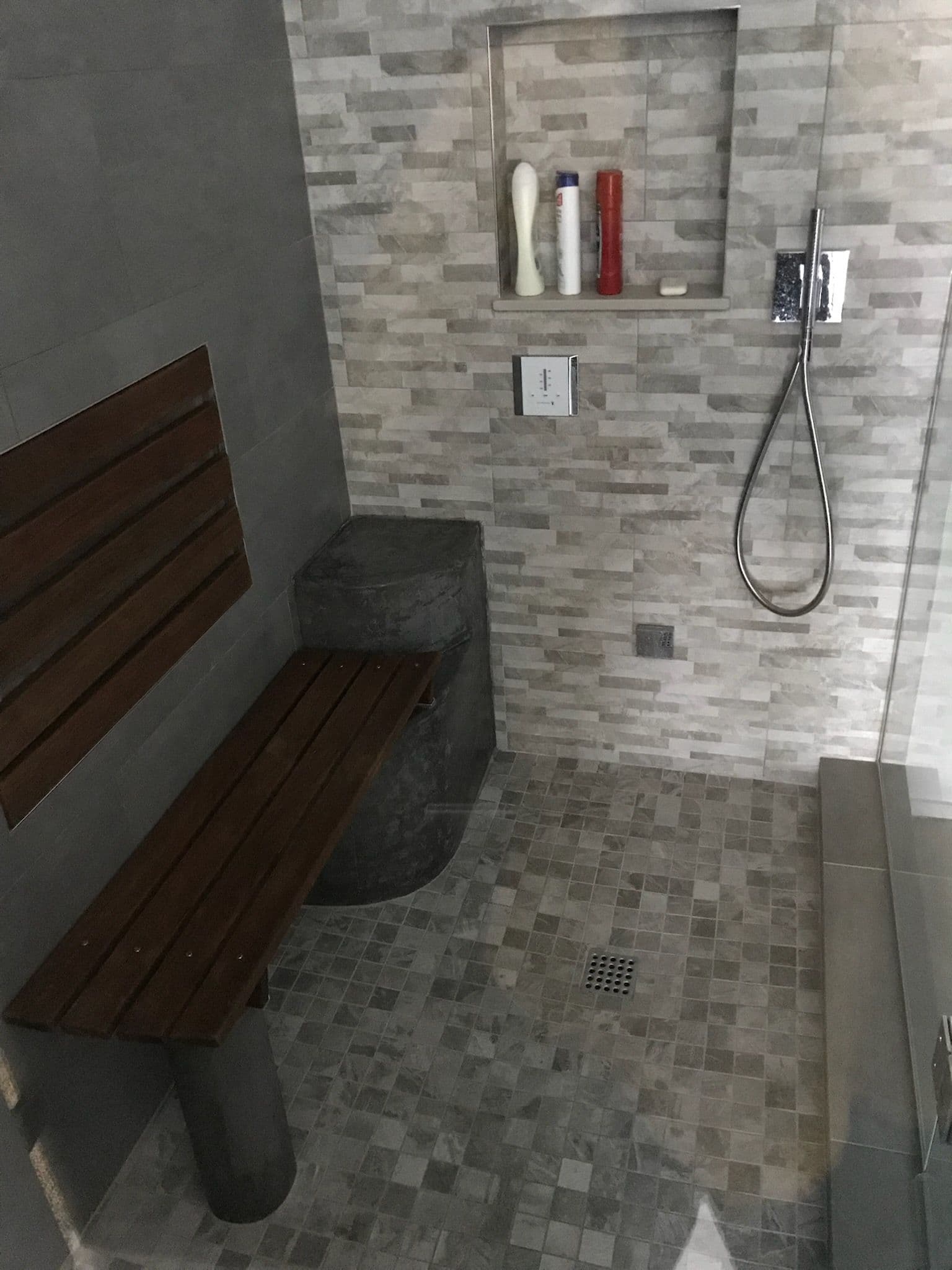 Luxury Stone-Tiled Shower Remodel with Steam Sauna image