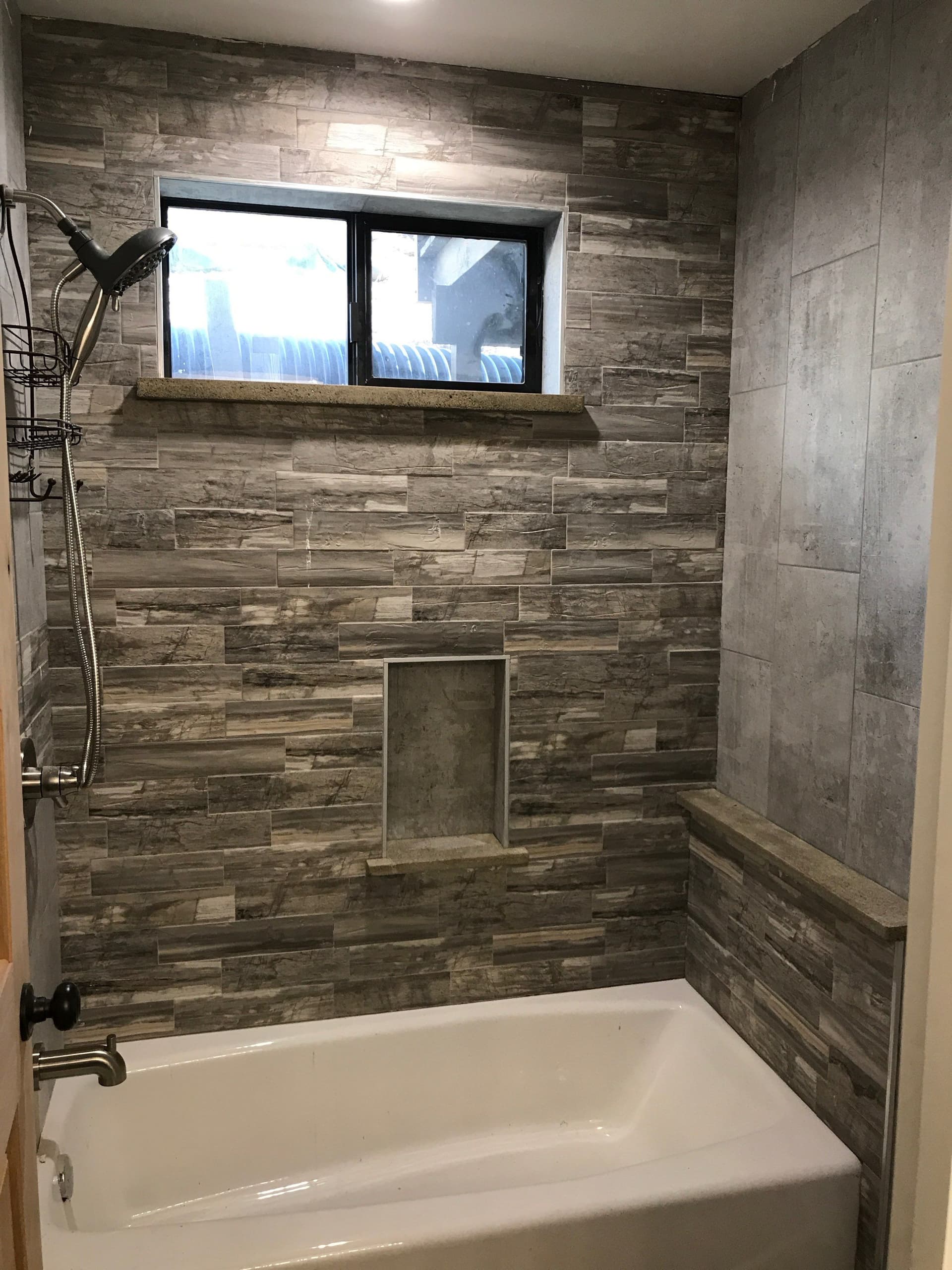 Sleek Shower Remodel with Gray Stone Tiles image